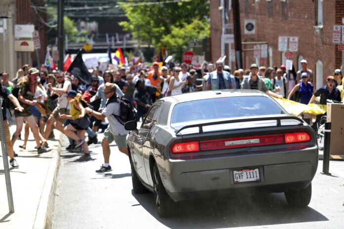 A car drives into a mass of protestors.