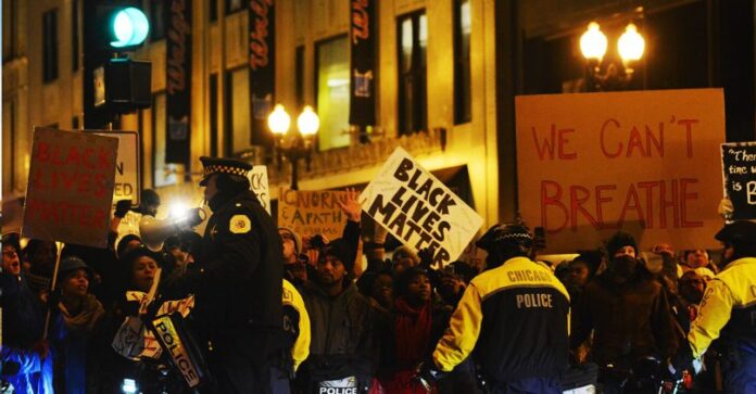 Protestors hold up 'Black Lives Matter' signs