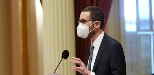 Man Wearing Mask Giving Speech On The Stage