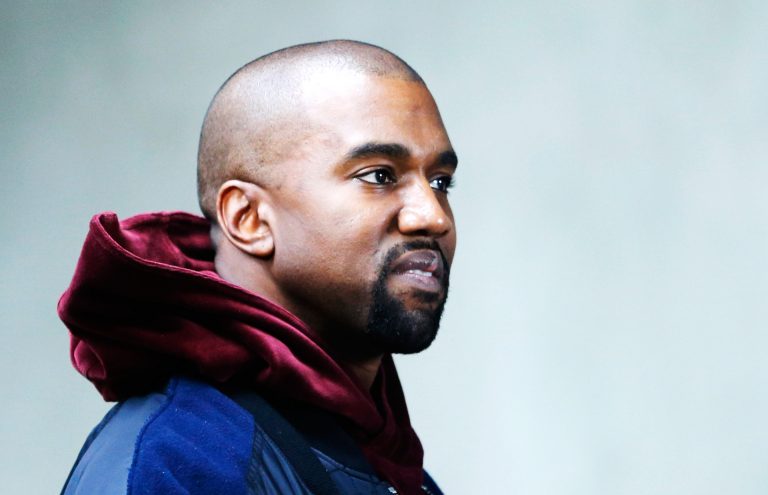 Photo Of Kanye West Wearing Blue and Maroon Hooded Jacket